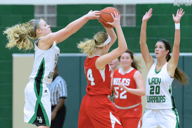 Jeff Lange | The Vindicator  West Branch's Melinda Trimmer (left) pokes the ball out of the hands of Niles' Braley Hale (center) while West Branch's Kaylee Manning looks to block the pass in the third quarter of their game, Monday night at West Branch High School. The Lady Warriors beat Niles with ease 76 to 26.
