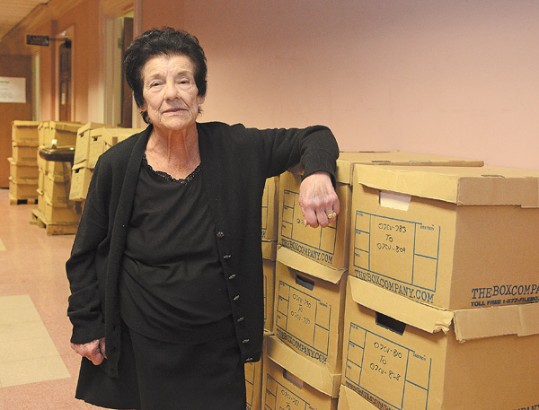Lucy DeMart, Mahoning County microfilm supervisor, stands with 2007 civil court case files in cardboard boxes
that await microfilming. Her department’s four-person staff has been overwhelmed by the backlog of paper
documents awaiting microfilming.