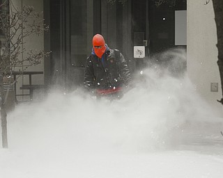        ROBERT K. YOSAY  | THE VINDICATOR..Looking like Boston - Joe Mowery of Western Reserve Enterprise uses a blower to remove the snow on the federal courthouses downtown.