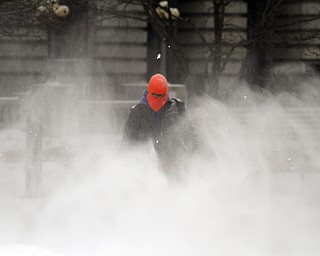        ROBERT K. YOSAY  | THE VINDICATOR..Looking like Boston - Joe Mowery of Western Reserve Enterprise uses a blower to remove the snow on the federal courthouses downtown.