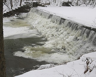 William D Lewis the Vindicator   Recent frigid cold temps left the Lake Glacier dam in in Mill Creek Park covered in a thick coating of ice.