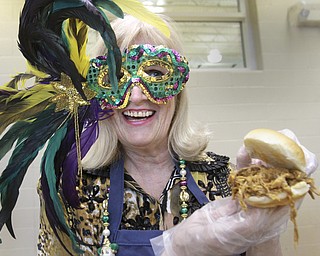 William D. Lewis The Vindicator Liz Shutler shows off a pulled pork sandwich she was serving during a Fat Tuesday event at the Salem Community Center. She was with a group from Auburn Skilled Nursing in Salem