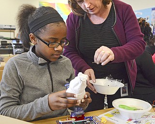 Katie Rickman | The Vindicator.Sharon Ragan (STEM teacher at Chaney High School) shows Jacasi Carmichael 13 of Youngstown make a snowman out of material and rice during the girls STEM after school program at Chaney High School on Feb. 18, 2015.