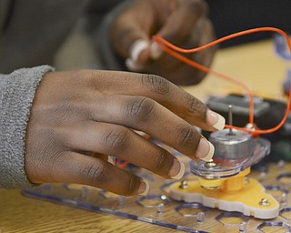 Katie Rickman | The Vindicator.A student works on snap circuit boards during the girls STEM after school program at Chaney High School on Feb. 18, 2015.