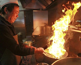 William d Lewis Xin Zheng, owner of Girard Wok prepares food for Chinese NewYear ceclebration.