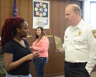 Katie Rickman | The Vindicator.Miyona Morgan, 17 of Warren speaks with Chief of Police Eric Merkel Warren City Council Chambers after the Key Club and Student Council from Warren G. Harding High School presented the WPD with a plaque on Thursday, Feb. 19, 2015.