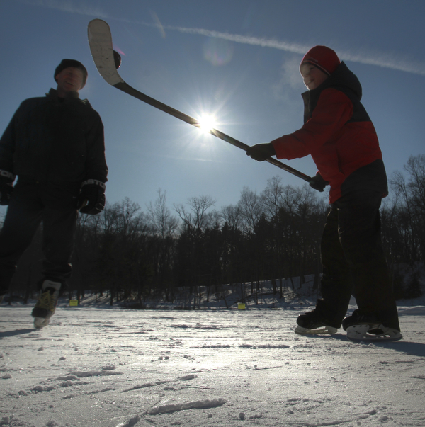 William D. Lewis the Vindicator Anatoliy Radchenko and his son Alex Radchenko, 11, of Poland take a break from skating at the Lily Pond in MCP 2-20-15.