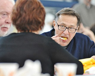 Jeff Lange | The Vindicator  Father Joseph Rudjak of Holy Apostles Parish in Youngstown eats pasta provided by one of the many cooks from the area, Sunday afternoon during the 13th annual Pasta Cook Off held at Blessed Sacrament Parish in Warren.