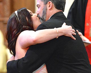 Jeff Lange | The Vindicator  Brian Daniszewski of North Lima (right) kisses his bride Jennifer Barber after being being pronounced man and wife by Rev. Jerry Krueger, Saturday morning during the walk-in weddings at Trinity United Methodist Church in Youngstown.