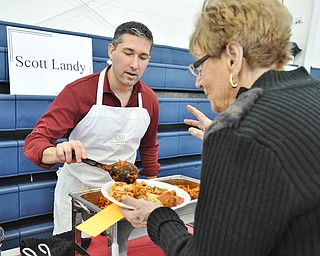 Jeff Lange | The Vindicator  Scott Landy of Boardman places a scoop of his pasta on an attendee's place during Sunday afternoon's 13th annual Pasta Cook Off held at Blessed Sacrament Parish in Warren.