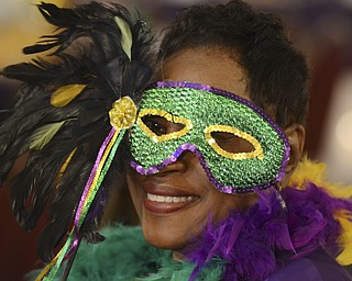 Katie Rickman | The Vindicator.Frances Curd of Boardman holds up her mask and smiles during the Junior Civic Leauge  4th AnnualMardi Gras Party at the Mahoning County Country Club in Liberty on Saturday, Feb. 21, 2015.