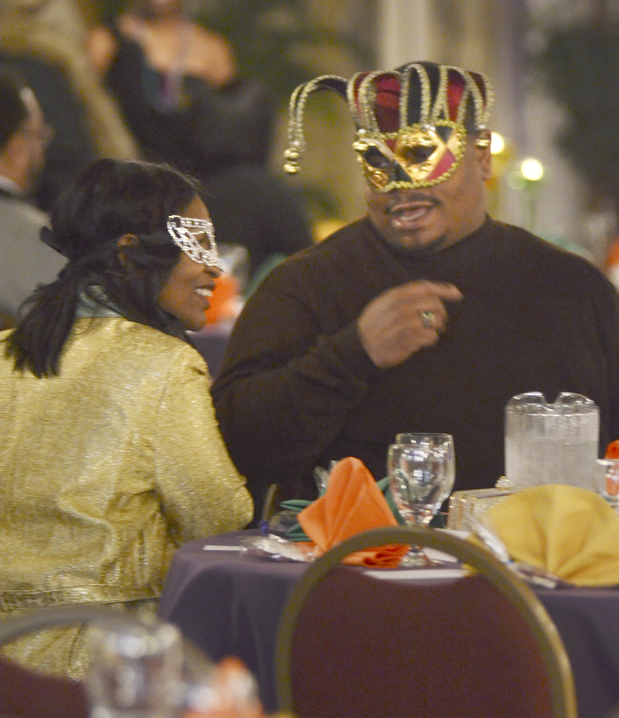 Katie Rickman | The Vindicator.Rodney and Addonnus Harden of Youngstown talk at their table during the Junior Civic League  4th AnnualMardi Gras Party at the Mahoning County Country Club in Liberty on Saturday, Feb. 21, 2015.