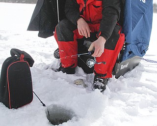        ROBERT K. YOSAY  | THE VINDICATOR..Mosquito Lake now almost 20 inches deep in ice had local anglers brave sub zero temps to fish.. Most say the fish from ice covered lakes are always best tasteing...David Parker and George Hrvatin (blue) both of Auburn Ohio.. spent tuesday fishing for  blue gill and walley