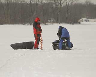        ROBERT K. YOSAY  | THE VINDICATOR..Mosquito Lake now almost 20 inches deep in ice had local anglers brave sub zero temps to fish.. Most say the fish from ice covered lakes are always best tasteing...David Parker and George Hrvatin (blue) both of Auburn Ohio.. spent tuesday fishing for  blue gill and walley
