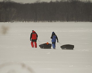        ROBERT K. YOSAY  | THE VINDICATOR..Mosquito Lake now almost 20 inches deep in ice had local anglers brave sub zero temps to fish.. Most say the fish from ice covered lakes are always best tasteing...David Parker and George Hrvatin (blue) both of Auburn Ohio.. spent tuesday fishing for  blue gill and walley