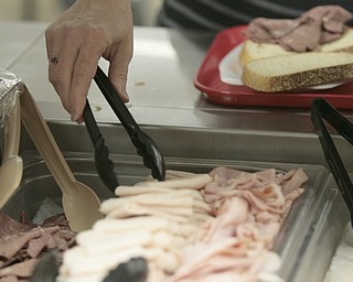        ROBERT K. YOSAY  | THE VINDICATOR..Fresh lunch meat is picked  for a Panini-.Canfield High School lunch time is  more the PBJ  - as  Panini's Salad home made soup ... etc  claims to be one of the best lunchrooms in the county ...