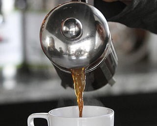        ROBERT K. YOSAY  | THE VINDICATOR..Coffe poured from a pressed coffee urn..Pressed Coffee Bar & Eatery recently opened On Lincoln Ave  across fromf Cushwa Hall....