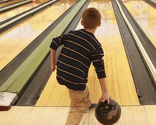 William D. Lewis The Vindicator  Ethan Warmouth, 8, of Austintown bowls in a after school youth bowling program at Camelot Lanes in Boardman