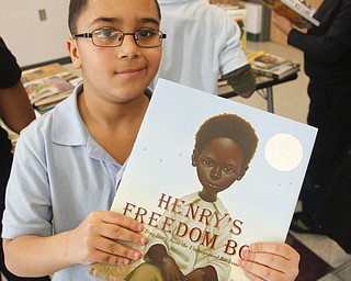        ROBERT K. YOSAY  | THE VINDICATOR..Lemuel Bonilla - and his book !. 50 books were donated to Discovery at Volney school Thursday by the Youngstown Alumnae Chapter of Delta Sigma Theta Sorority, Inc. The sorority also donated a $250 check which Principal Misha Scott said will be used to by more books for the school.