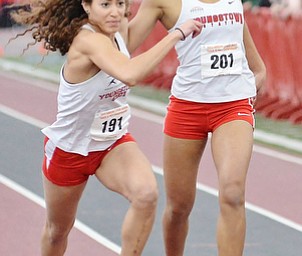 Jeff Lange | The Vindicator  Megan Gunther of Youngstown (left) takes the handoff from teammate Taylor McDonald during the second heat of the women's 4x400 meter relay, Sunday afternoon at the Horizon League Indoor Track Championship in Youngstown.