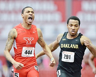 Jeff Lange | The Vindicator  Youngstown's Marcellus Embry (444) celebrates as he passes Oakland's Aaron Davis (291) just before the finish line of the first heat of the men's 200 meter dash, Sunday afternoon in Youngstown.