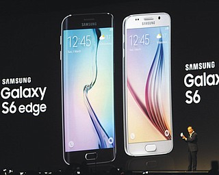 J.K. Shin, CEO of Samsung’s mobile division, shows the new Galaxy S6 and S6 Edge during a Samsung Galaxy Unpacked 2015 event on the eve of this week’s Mobile World Congress wireless show in Barcelona, Spain, on Sunday. Samsung unveiled a stylish new flagship phone that ditches its signature plastic design for metal and glass.