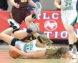 Jeff Lange | The Vindicator  West Branch's Pavin Heath (left) gets tangled up with Southeast's Riley Norquest late in the fourth quarter of their sectional matchup in Austintown, Monday evening. The Lady Warriors beat the Pirates 64 to 52.