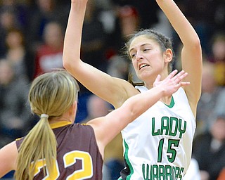 Jeff Lange | The Vindicator  Lady Warriors' Emily Menegay (15) looks back to make a pass over Pirates' defender Madison Dunn (22) in the second quarter of their sectional semi-final game, Monday night in Austintown. West Branch beat Southeast 64 to 52.