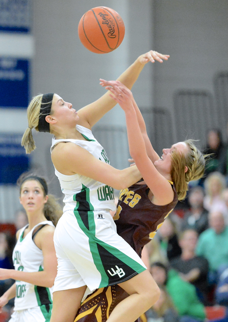Jeff Lange | The Vindicator  West Branch's Pavin Heath (left) smacks down a pass thrown by Southeast's Madison Dunn during early third quarter action of their sectional semi final game at Austintown Fitch High School, Monday night. The Lady Warriors beat the Pirates 64 to 52.