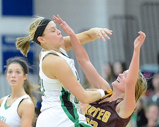 Jeff Lange | The Vindicator  West Branch's Pavin Heath (left) collides with Southeast's Madison Dunn as she throws a pass during early third quarter action of their sectional semi final game at Austintown Fitch High School, Monday night. The Lady Warriors beat the Pirates 64 to 52.