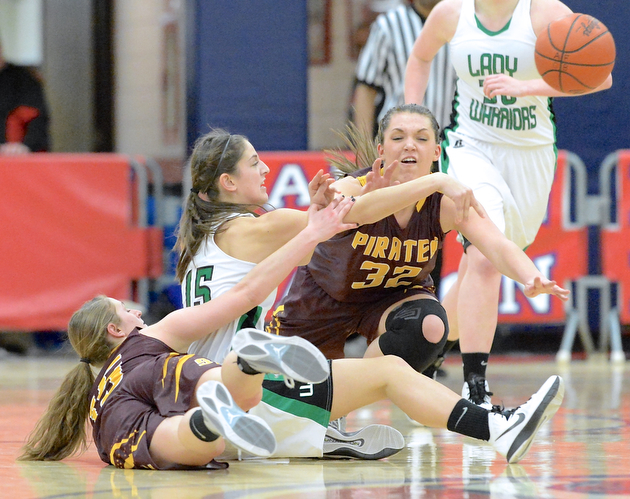 Jeff Lange | The Vindicator  West Branch's Emily Menegay (middle) throws a pass from the floor as she's pressured by Southeast's Riley Torquiest (15) and Natalie Zuchowski (32) during second half action of their sectional semi-final matchup, Monday night in Austintown. The Lady Warriors beat Southeast 64-52.