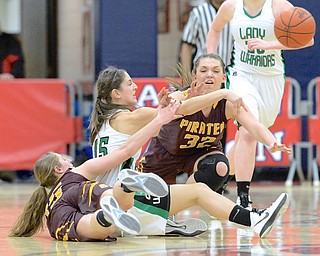 Jeff Lange | The Vindicator  West Branch's Emily Menegay (middle) throws a pass from the floor as she's pressured by Southeast's Riley Torquiest (15) and Natalie Zuchowski (32) during second half action of their sectional semi-final matchup, Monday night in Austintown. The Lady Warriors beat Southeast 64-52.