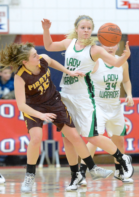 Jeff Lange | The Vindicator  West Branch's Melinda Trimmer (right) reaches to grab the ball over Southeast's Riley Norquest (15) during fourth quarter action of Monday night's sectional semi-final game in Austintown.
