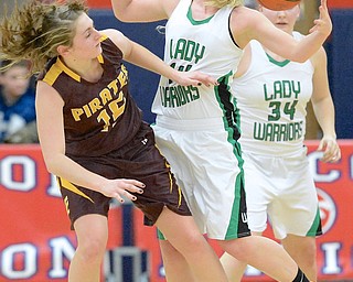 Jeff Lange | The Vindicator  West Branch's Melinda Trimmer (right) reaches to grab the ball over Southeast's Riley Norquest (15) during fourth quarter action of Monday night's sectional semi-final game in Austintown.