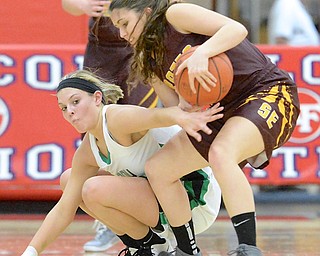 Jeff Lange | The Vindicator  Lady Warrior's Pavin Heath (left) reaches to steal the ball away from Southeast's Rachel Stull late in the second half of their sectional semi-final game in Austintown, Monday evening.