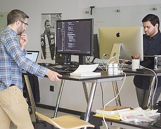 John Mela of Boardman, a mobile software engineer, left, and Adam Magana of Boardman, lead mobile developer, work at Drund’s Boardman office Thursday. Magana said he was the first to be hired, and has been with the technology company for almost five years.