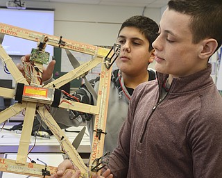 Katie Rickman | The Vindicator.Canfield Middle School students Gio Saadey (left) and Fletcher Christi look at the handmade drone that they had a part in making through a STEM class on Feb. 26, 2015.