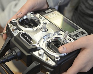 Katie Rickman | The Vindicator.A student holds the controller that controls the handmade drone that Canfield Middle School students have been working on in a STEM class.