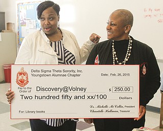        ROBERT K. YOSAY  | THE VINDICATOR..Adults  are Misha Scott - Princiapal  Dr  Michelle McCollin -. 50 books were donated to Discovery at Volney school Thursday by the Youngstown Alumnae Chapter of Delta Sigma Theta Sorority, Inc. The sorority also donated a $250 check which Principal Misha Scott said will be used to by more books for the school.