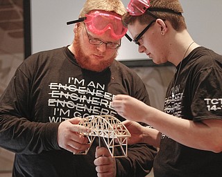        ROBERT K. YOSAY  | THE VINDICATOR..Brent Kidwell - and Sal Thomas  of TCTC do some last minute adjustments as they prepare to see how much weight it can hold ..Thirty-five teams from 18 area high schools did thier best at building the best foot-long balsa-wood bridge at the 8th annual Miniature Bridge Building Competition Friday, Feb. 27, in Kilcawley Center at Youngstown State University..