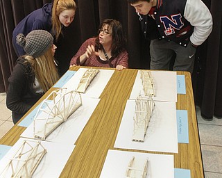        ROBERT K. YOSAY  | THE VINDICATOR..Stephanie Thomas  Niles  director talks to her students -  Morgan Estes -Kameryn Delvecchio and Jared Tate... about the other bridges ..Thirty-five teams from 18 area high schools did thier best at building the best foot-long balsa-wood bridge at the 8th annual Miniature Bridge Building Competition Friday, Feb. 27, in Kilcawley Center at Youngstown State University..