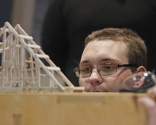        ROBERT K. YOSAY  | THE VINDICATOR..Dennis Dellinger   watches his bridge as weight is added....Thirty-five teams from 18 area high schools did thier best at building the best foot-long balsa-wood bridge at the 8th annual Miniature Bridge Building Competition Friday, Feb. 27, in Kilcawley Center at Youngstown State University..