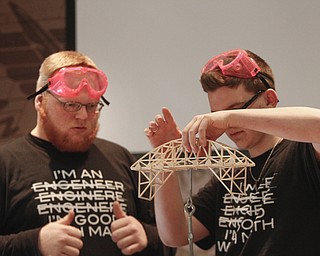        ROBERT K. YOSAY  | THE VINDICATOR..Brent Kidwell - and Sal Thomas  of TCTC do some last minute adjustments as they prepare to see how much weight it can hold ..Thirty-five teams from 18 area high schools did thier best at building the best foot-long balsa-wood bridge at the 8th annual Miniature Bridge Building Competition Friday, Feb. 27, in Kilcawley Center at Youngstown State University..