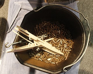        ROBERT K. YOSAY  | THE VINDICATOR..splinters and the weights end up  the weight bucket - at the end of the trial..Thirty-five teams from 18 area high schools did thier best at building the best foot-long balsa-wood bridge at the 8th annual Miniature Bridge Building Competition Friday, Feb. 27, in Kilcawley Center at Youngstown State University..
