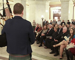 William D. Lewis The Vindicator Ralph Meachum family , friends and others listen to bagpiper Stephen Sutherland Holter in the Mahoning County Courthouse rotunda for Meachum's swearing in as county auditor 3-3-15.