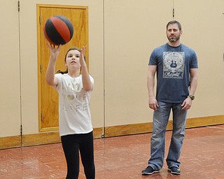 Katie Rickman | The Vindicator.Sara Congemi 10, of Boardman shoots hoops during a game of “knock out” as her father Bill Schaper watches her make the basket during Gym Night with Dad at Stadium Drive Elementary School. Approximately 84 attended the night of fun which included the entire fourth grade class.