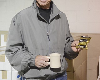 Katie Rickman | The Vindicator.Richard Marlowe, owner of Marlowe's Premium Coffee Service in Canfield holds a packet of their premium blend coffee at their distribution warehouse on Wednesday, March 4, 2015.