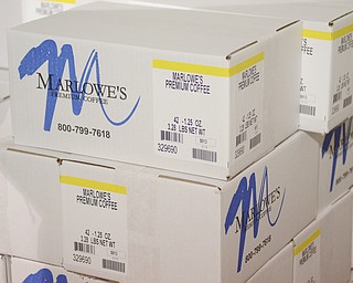 Katie Rickman | The Vindicator.Boxes of premium coffee stacked inside the distribution warehouse in Canfield.