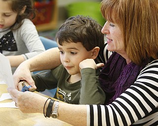        ROBERT K. YOSAY  | THE VINDICATOR..Poland Union Elementary pre school program .. will be expanded and moved to Poland North - Next school year .Helping hand as Mrs Lisa Caldwell helps  Preschooler Ian Doll cut out a shamrock