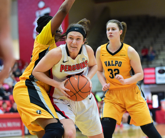YOUNGSTOWN, OHIO - MARCH 7, 2015: Heidi Schlegel #15 of YSU spins to the basket inside of Sharon Karungi #33 of Valpo during the 1st half of Saturday afternoons NCAA basketball game at Beeghly Center. (Photo by David Dermer/Youngstown Vindicator) Dani Franklin #32 of Valpo pictured.